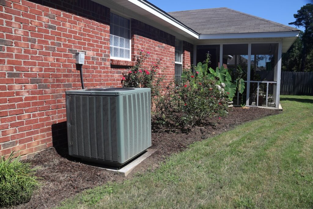 outdoor ac unit next to a brick home