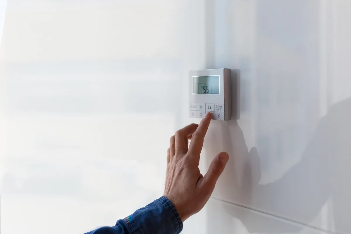 The air conditioning and heating control thermostat