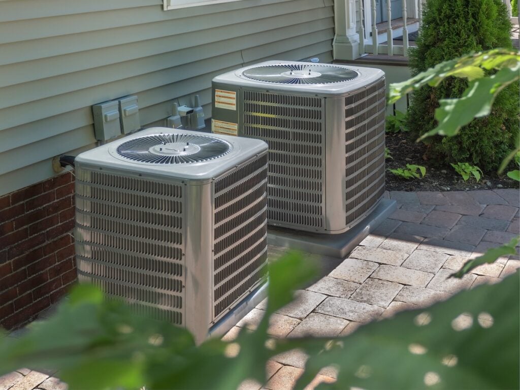 two outdoor air conditioning units next to eachother