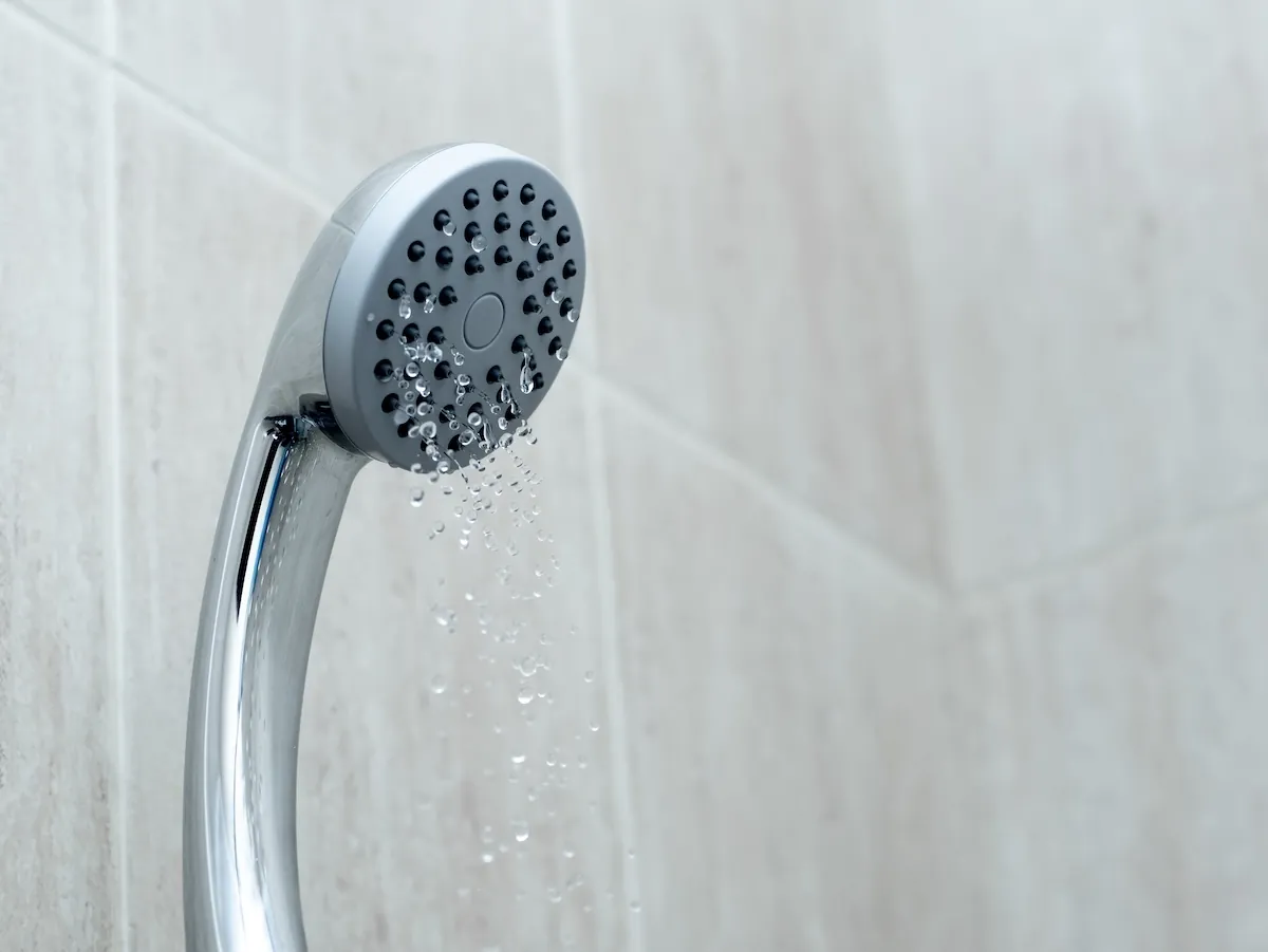 Shower head with low water stream. Broken shower in the bathroom