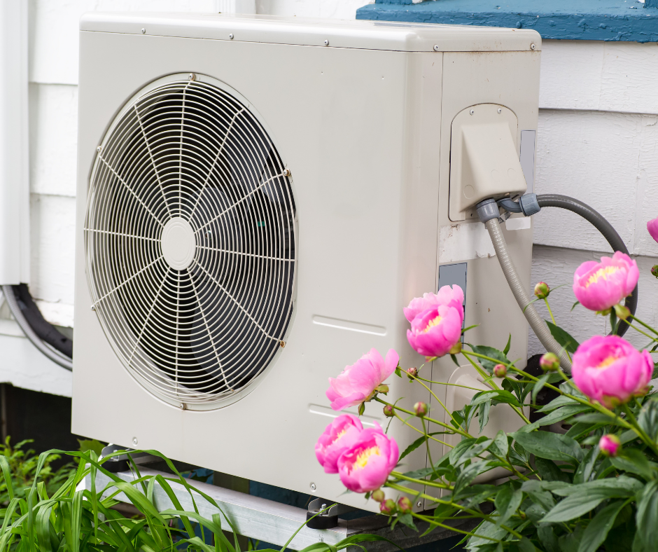 Air-source heat pump outdoor unit beside a Twin Cities home.