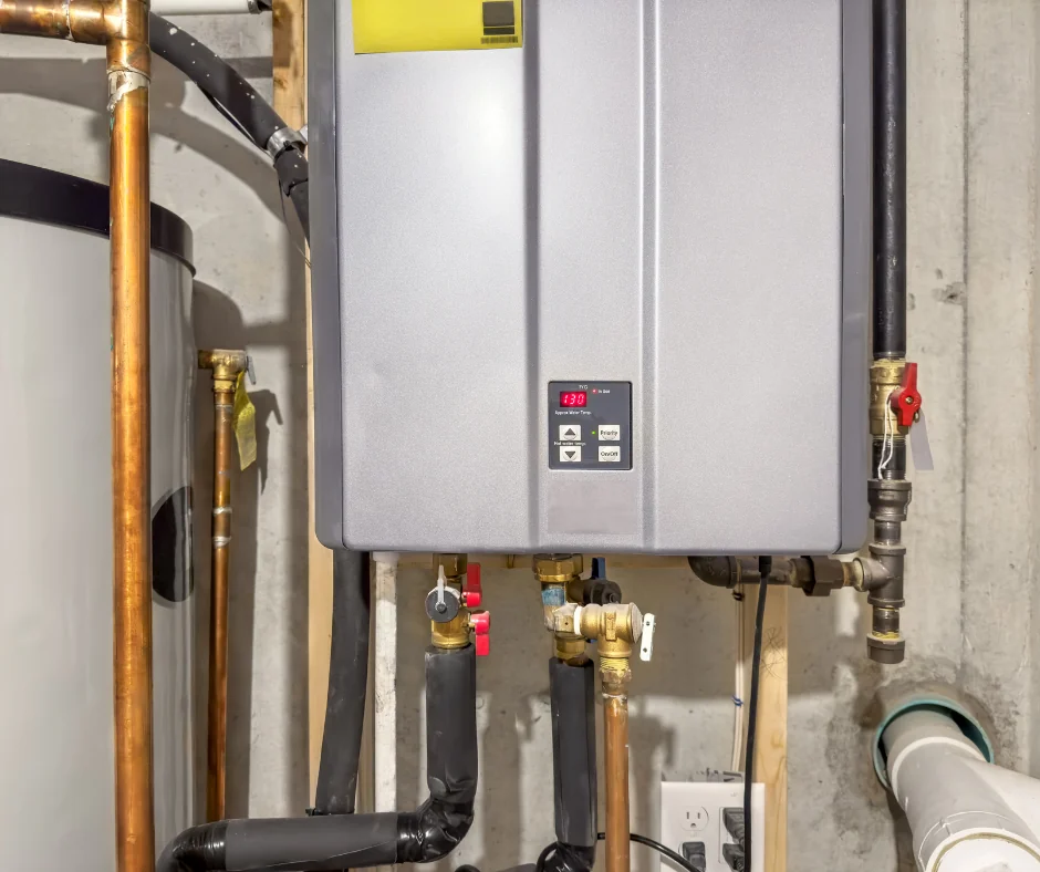 Wall-mounted tankless water heater with copper piping in a basement.