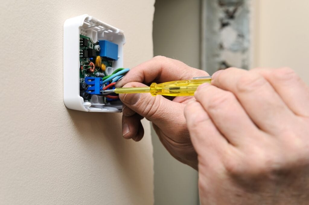 Installing a programmable room thermostat. 