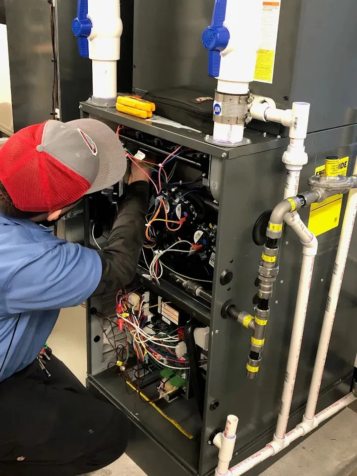 genz ryan technician working on a gas furnace