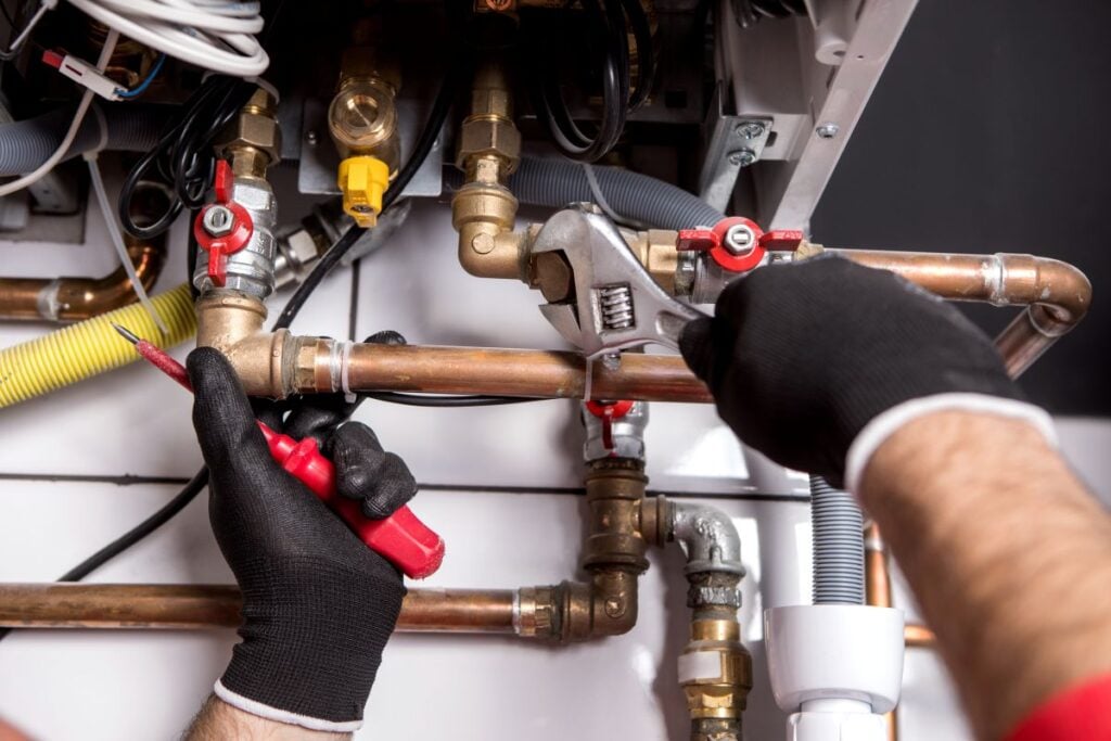 a plumber fixing central heating system