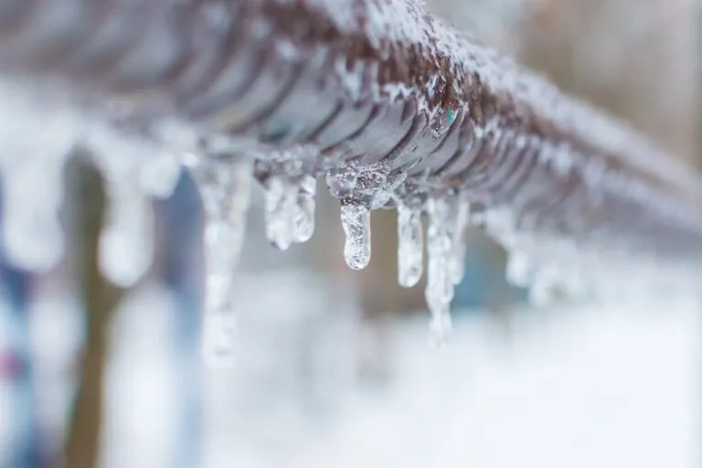 frozen icicles after rain on the pipe