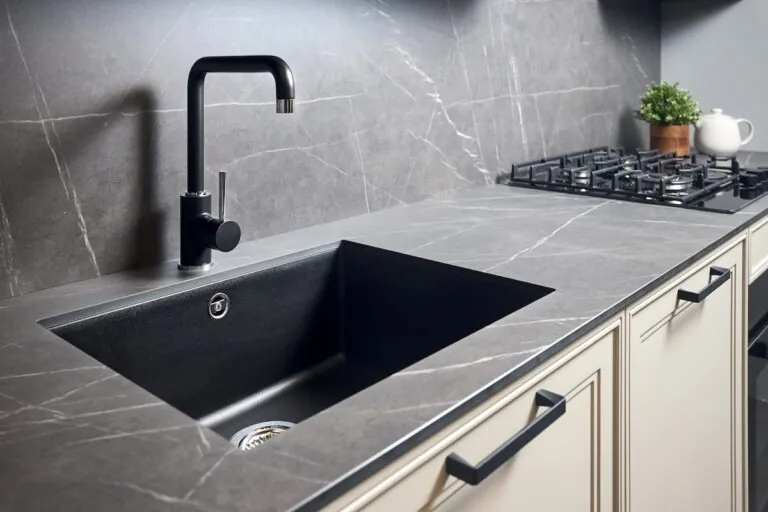 Kitchen sink area with black square matte sink tap in contemporary style