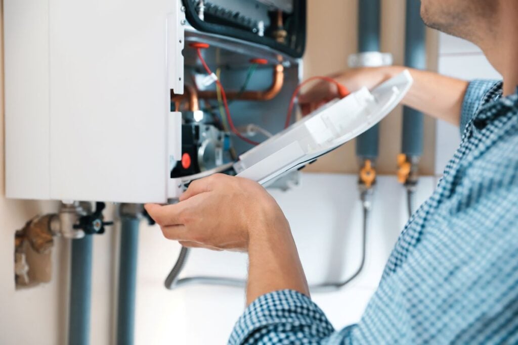 Man opening top of gas boiler, closeup