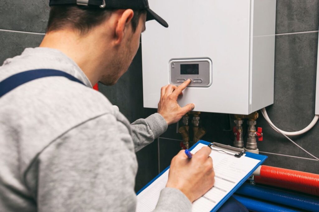 Technician servicing holding clipboard and inspecting heating system