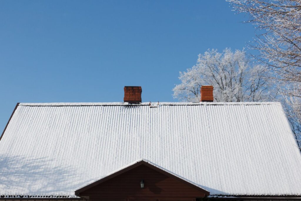 snow covered roof against a blue sky