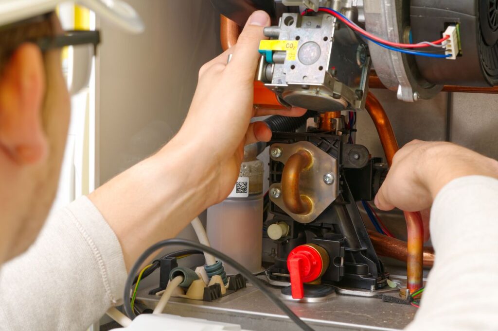 Maintenance and Repair of a gas boiler, setting up and servicing. Technician servicing the gas boiler for hot water and heating