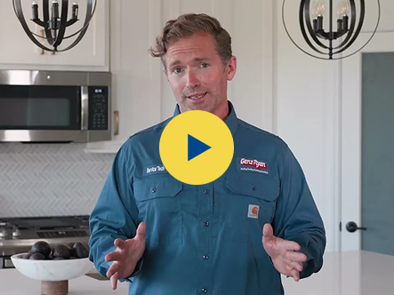 Video thumbnail: man in a blue work shirt speaking in a modern kitchen, gesturing with hands toward the camera.