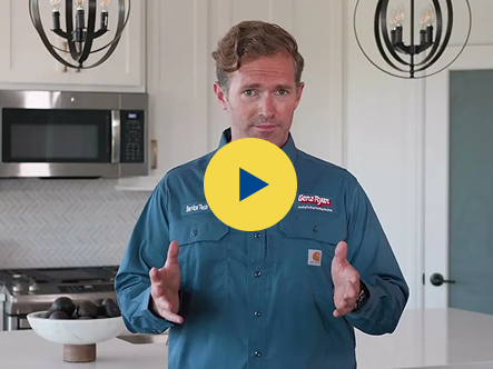 Video thumbnail: man in a blue work shirt explaining in a modern kitchen with pendant lights, gesturing with his hands.