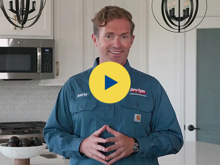 Video thumbnail: man in a blue work shirt standing in a bright kitchen, smiling with hands clasped in front of him.