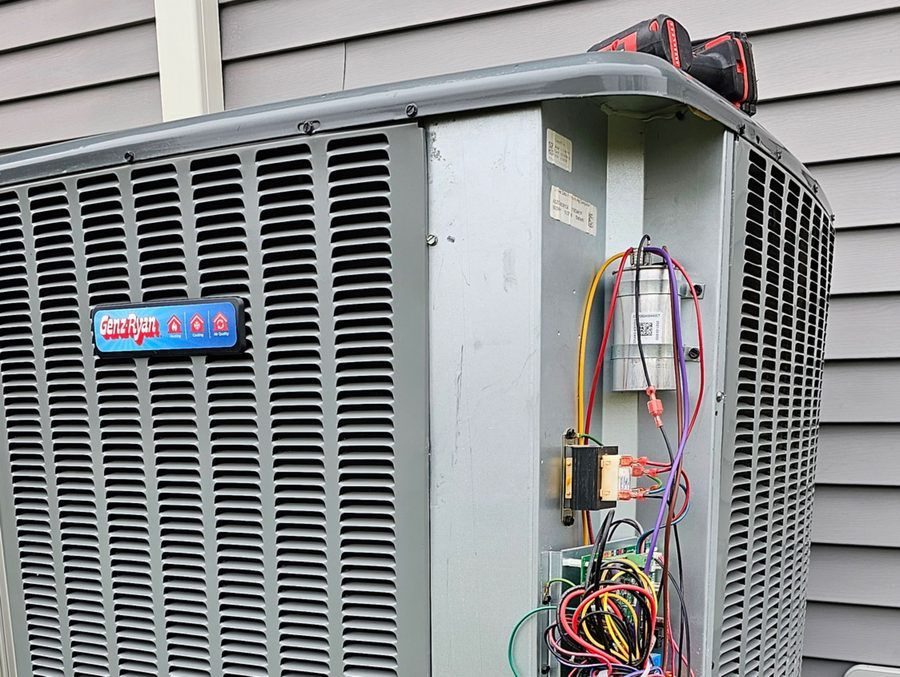 AC repair on an outdoor HVAC unit.